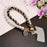 Pearl Wrist Phone Lanyard with Hand-Woven Leather & Floral Accent