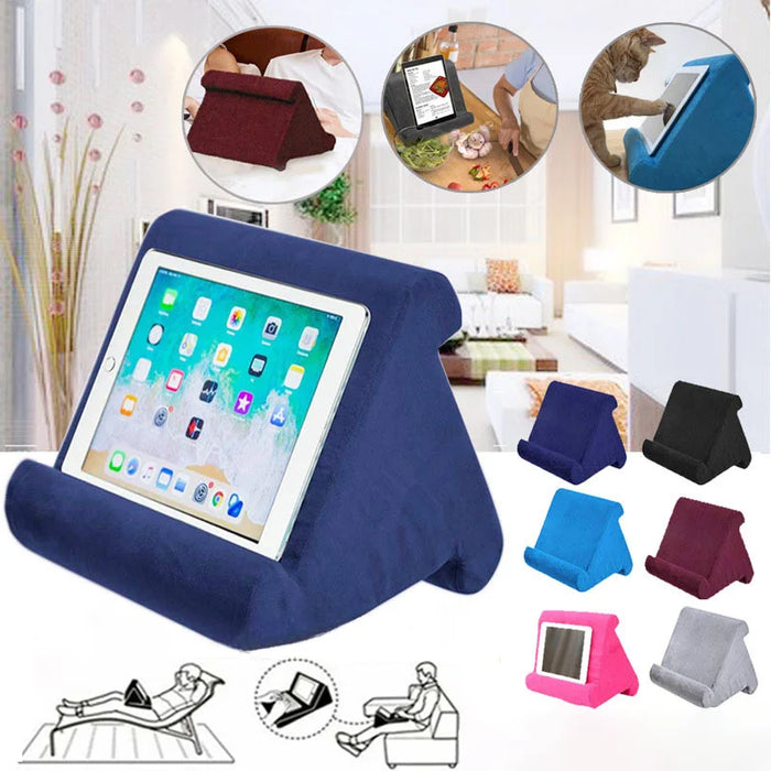Multifunctional pillow-type tablet and phone holder, suitable for iPad and other devices, made from sponge material for added comfort.