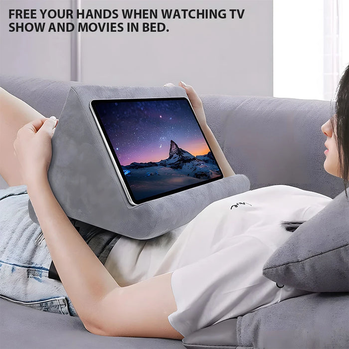 Multifunctional pillow-type tablet and phone holder, suitable for iPad and other devices, made from sponge material for added comfort.